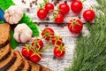 Still life: cherry tomatoes, black bread, garlic, fennel, bayber Royalty Free Stock Photo