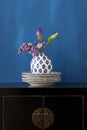 Still life with a Chinese cabinet and flowers in a little vase Royalty Free Stock Photo