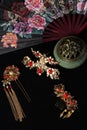 Still life in Chinese style. traditional hairpins, incense burner and fan isolated on black background Royalty Free Stock Photo