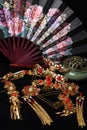Still life in Chinese style. traditional hairpins, incense burner and fan isolated on black background Royalty Free Stock Photo