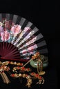 Still life in Chinese style. traditional hairpins, incense burner and fan isolated on black background Royalty Free Stock Photo