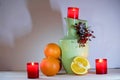 still life with a jug, candles and oranges Royalty Free Stock Photo