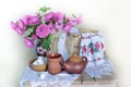 Tea pair and pink flowers in a vase on a white background . Royalty Free Stock Photo