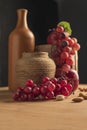 Still life with a clay pot and grapes and an apple Royalty Free Stock Photo