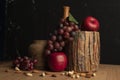 Still life with a clay pot and grapes and an apple Royalty Free Stock Photo