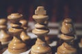 Still life close up detail view of a queen chess dark wooden piece on a chess board while a strategic game is being played. Interi Royalty Free Stock Photo