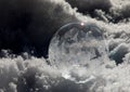 Close-up of Frozen Soap Bubble with Ice Crystals in Snow Royalty Free Stock Photo