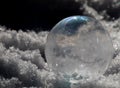 Close-up of Frozen Soap Bubble with Ice Crystals in Snow Royalty Free Stock Photo