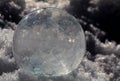 Close-up of Frozen Soap Bubble with Ice Crystals in Snow Royalty Free Stock Photo