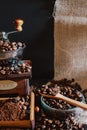 Still life with coffee beans and old coffee mill on the rustic background