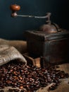 Coffee beans and vintage coffee grinder. Roasted coffee beans in a vintage setting. Dark still life Royalty Free Stock Photo