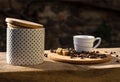 Still life with coffee cup, beans and sugar bowl in the sun Royalty Free Stock Photo