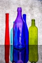 Still life with colored bottles on a reflective surface Royalty Free Stock Photo