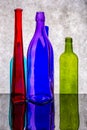 Still life with colored bottles on a reflective surface Royalty Free Stock Photo
