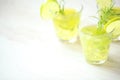 Still life with colorful bright cocktails on wooden background, decorated with rosemary and lime Royalty Free Stock Photo