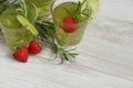 Still life with colorful bright cocktails on wooden background, decorated with rosemary, strawberry and lime Royalty Free Stock Photo