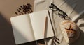 Aesthetic flat lay featuring an open notebook reading glasses coffee beans and a decorative skull under warm sunlight Royalty Free Stock Photo