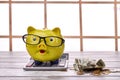 Still life composition of piggy bank with calculator and cash. Royalty Free Stock Photo