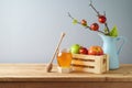 Still life composition for Rosh Hashanah holiday. Honey jar and apples in wooden box on table background Royalty Free Stock Photo