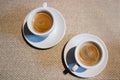 Still-life composition, two white coffee cups, white serving plates, small spoons