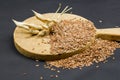Still life composition with wooden kitchen cutting board, dried radish pods and flax seeds