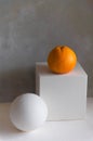 Still life concept with grape fruit on white geometric cube with sphere on the side Royalty Free Stock Photo