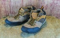 Still- life concept hiking boots or outdoor shoes on sack sisal