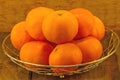 still life concept many orange in alumunum basket on black wooden background