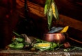 Still life with corn and copper pan