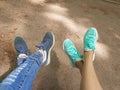 Still life. Crossed with each other two pairs of legs in stylists. One pair of legs in blue torn jeans and blue robes with blue l