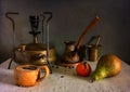 Still life with a cup of aromatic coffee brewed in a Ãâurk on an old primus stove. Nearby lies a pear and mandarin.