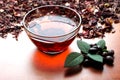 Still life cup of black tea with mint leaves on dried karkade tea background