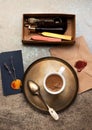 Still life with cup coffee, envelope with wax stamp and wax seal