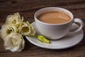 Still life with cup of coffee and flowers Eustoma on wooden back Royalty Free Stock Photo