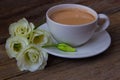 Still life with cup of coffee and flowers Eustoma on wooden back Royalty Free Stock Photo