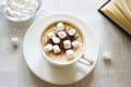 Still life with a Cup of coffee, marshmallows and a book. Royalty Free Stock Photo