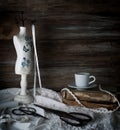 Still-life with a cup of coffee, scissors, mannequin sewing and lace on a background of rough wooden walls. vintage Royalty Free Stock Photo