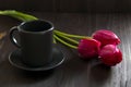 Still life with a cup of coffee and tulip. bouquet of tulips with black coffee cup Royalty Free Stock Photo