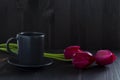 Still life with a cup of coffee and tulip. bouquet of tulips with black coffee cup Royalty Free Stock Photo