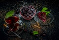 Still life with a Cup of strong tea, ripe cherries and cherry cake on a black background Royalty Free Stock Photo