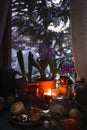 Still life with a cup of tea, burning candle and hyacinth flowers in pots in front of frozen winter window, cozy evening Royalty Free Stock Photo