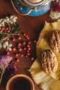 Still life of cup of tea, flowers and berries on the wooden board. Royalty Free Stock Photo