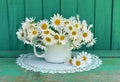 Still life with daisy flowers in white cup