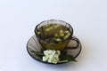 Still life with a dark glass cup with herbal hot jasmine tea Royalty Free Stock Photo