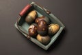 Still life of decorated wooden eggs in a green crate Royalty Free Stock Photo