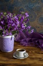 The bouquet of plant Matthiola farinosa and cup of coffee close-up
