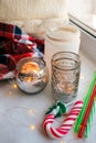 Still life details with candles, toy candy cane and garland. Scandinavian hygge concept, christmas and new year stll life. Royalty Free Stock Photo