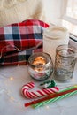 Still life details with candles, toy candy cane and garland. Scandinavian hygge concept, christmas and new year stll life Royalty Free Stock Photo