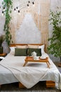 Still life details in home interior of light bedroom in bohemian chic style. Breakfast on the bed Royalty Free Stock Photo