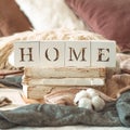 Still life details in home interior of living room and the inscription HOME. Books and cup of tea with cone and cotton. Read. Rest Royalty Free Stock Photo